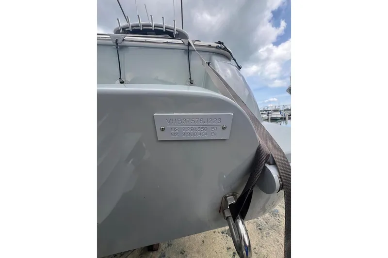 Slide: The Image of 2023 Valhalla Boatworks V-37 with identification plate, docked under cloudy sky. - 10