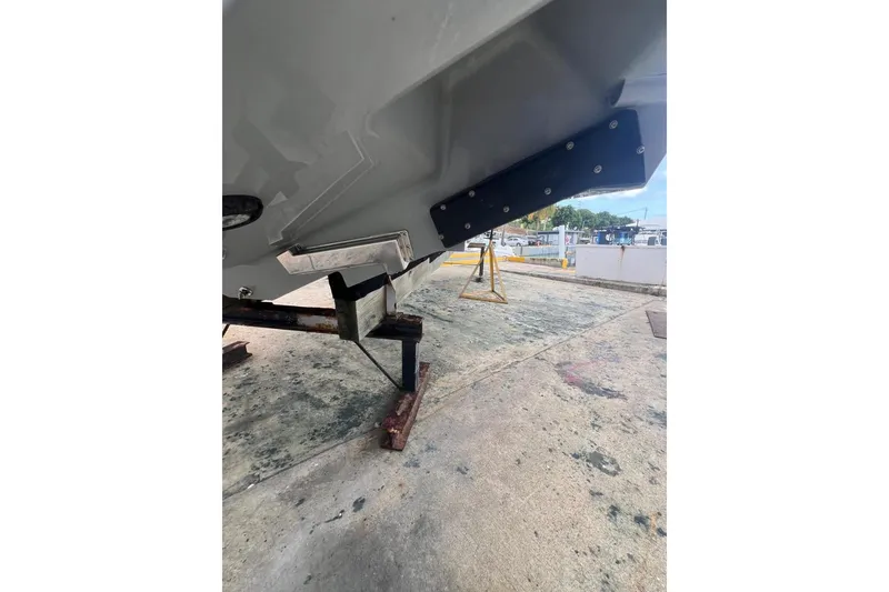 Slide: The Image of 2023 Valhalla Boatworks V-37 hull detail on a stand, outdoor setting. - 12