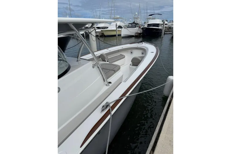 Slide: The Image of 2023 Valhalla Boatworks V-37 docked, showcasing sleek design and spacious deck. - 6