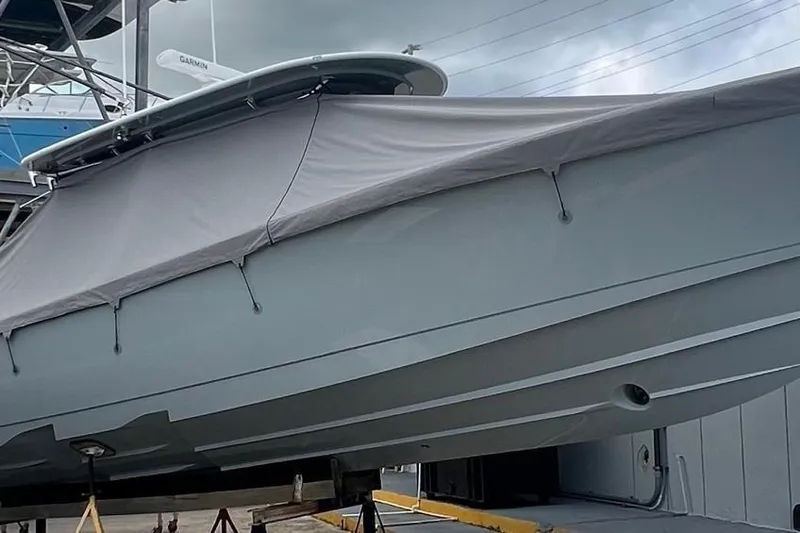 Slide: The Image of 2023 Valhalla Boatworks V-37 covered, docked, showcasing sleek design and modern features. - 9