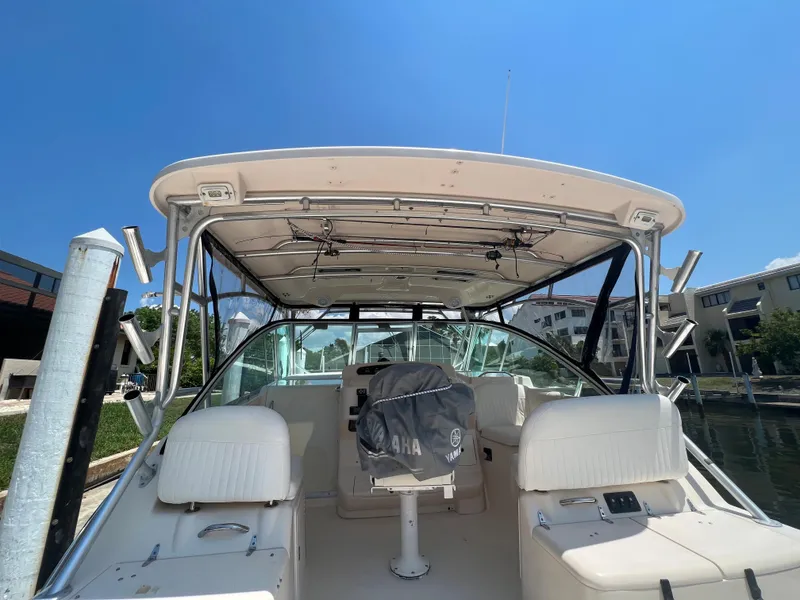 Slide: The Image of 2006 Grady-White 360 Express boat interior with seating, docked under clear blue sky. - 2
