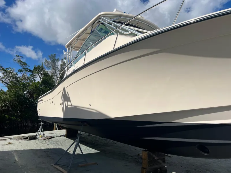 Slide: The Image of 2006 Grady-White 360 Express boat on dry dock under blue sky. - 26