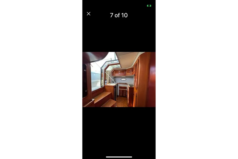 Slide: The Image of Interior of a 1987 Tiara 3600 yacht with wooden cabinetry and seating. - 11