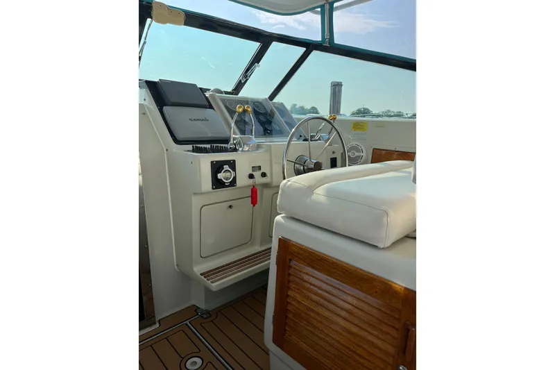 Slide: The Image of Interior of a 1987 Tiara 3600 boat with steering wheel and navigation equipment. - 4