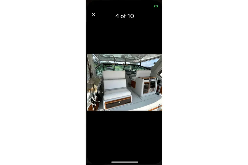 Slide: The Image of Interior view of 1987 Tiara 3600 boat, featuring seating and helm area. - 8