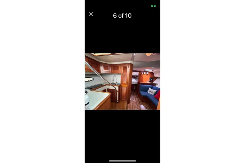 Slide: The Image of Interior of 1987 Tiara 3600 yacht with wood finishes and cozy seating area. - 9
