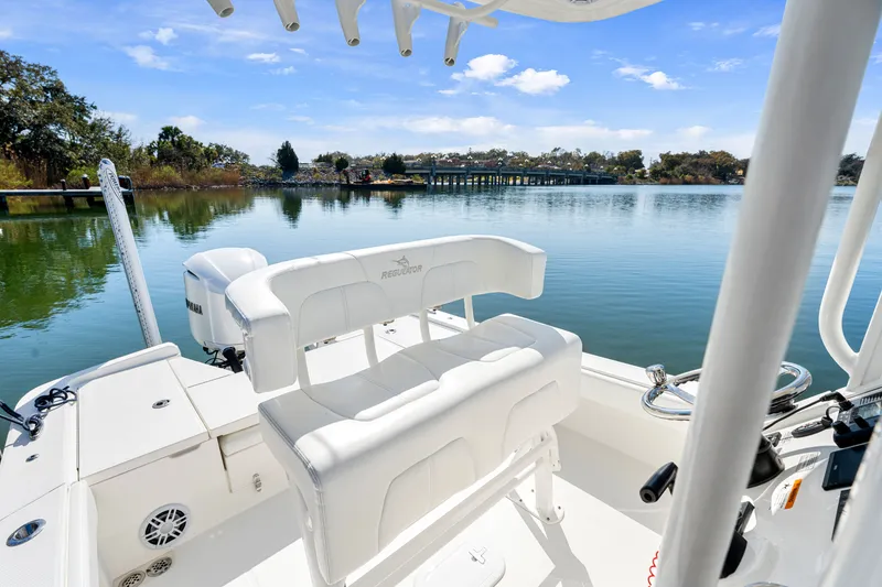 Slide: The Image of Regulator 24XO 2021 boat on calm lake with clear view. - 13
