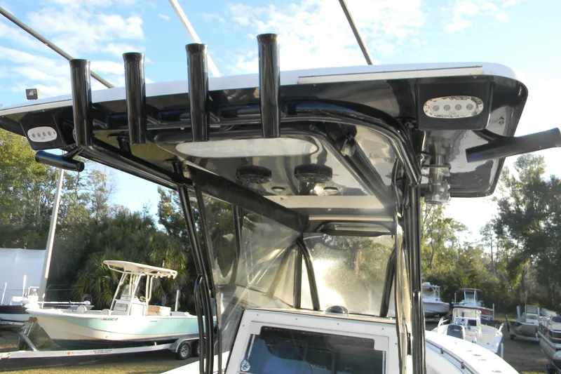Slide: The Image of 2015 SeaHunter 35 Tournament boat with T-top and rod holders, docked outdoors. - 11