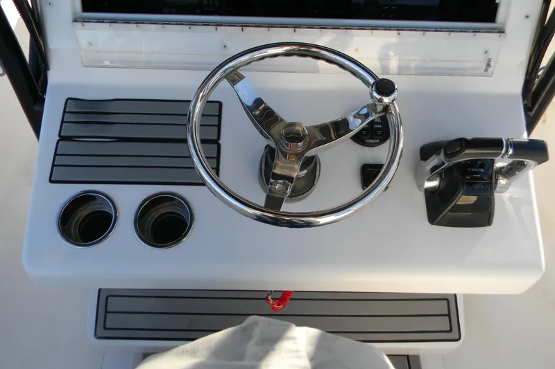 Slide: The Image of 2015 SeaHunter 35 Tournament helm with steering wheel and controls. - 16