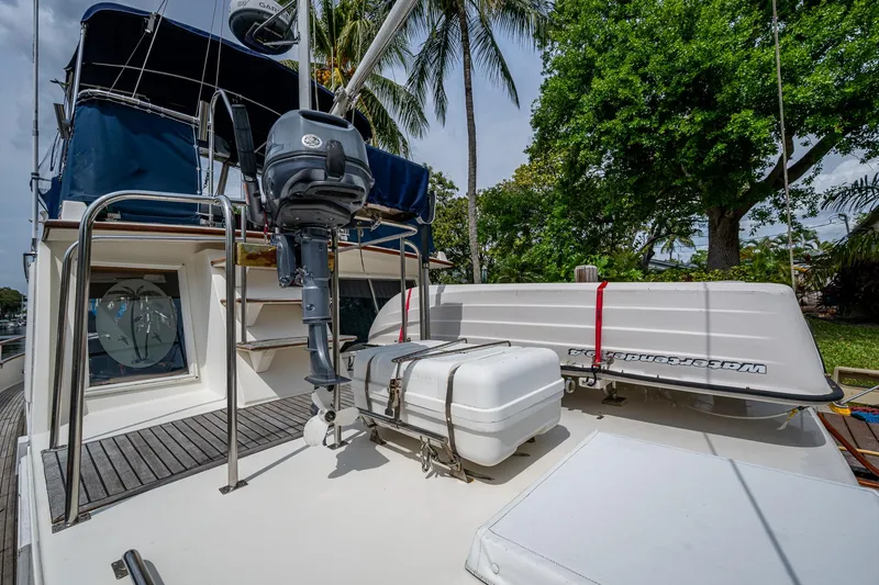 Slide: The Image of 1990 Grand Banks 46 Classic yacht deck with equipment and lush greenery background. - 12