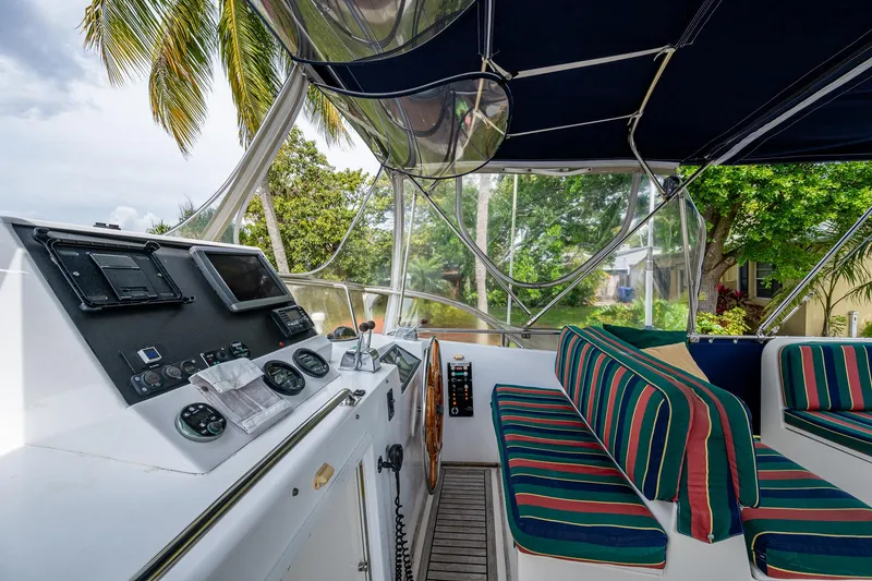 Slide: The Image of Helm of 1990 Grand Banks 46 Classic with striped seating and navigation instruments. - 17