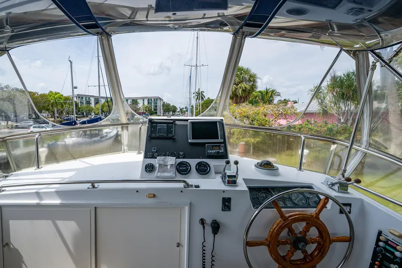 Slide: The Image of Helm of 1990 Grand Banks 46 Classic yacht with navigation equipment and wooden steering wheel. - 18