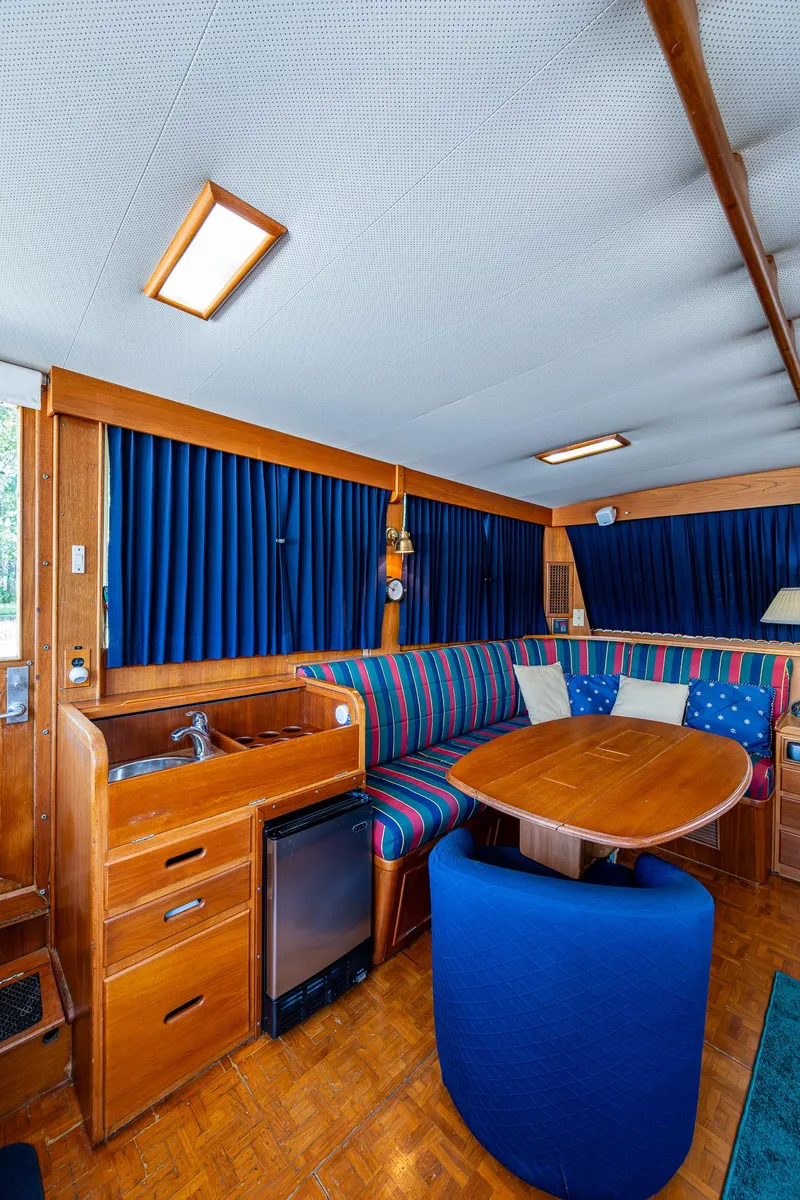 Slide: The Image of Interior of 1990 Grand Banks 46 Classic yacht with wood finish and blue upholstery. - 24