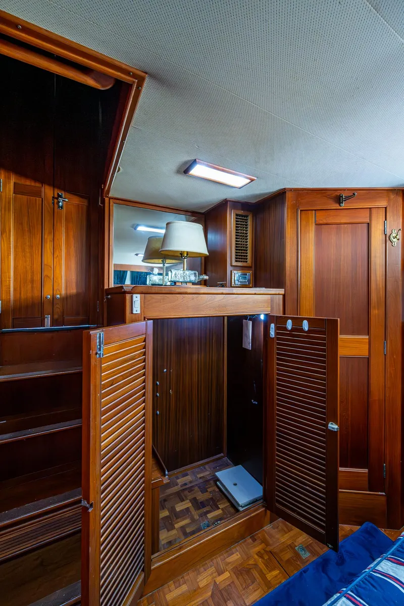 Slide: The Image of Interior of 1990 Grand Banks 46 Classic yacht with wooden cabinetry and parquet flooring. - 48