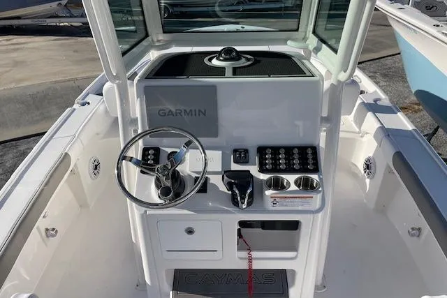 Slide: The Image of 2026 Caymas 24 HB boat console with Garmin navigation system and steering wheel. - 6