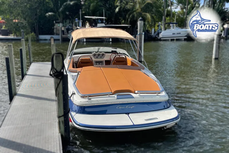 Slide: The Image of 2016 Chris-Craft Capri 21 boat docked, featuring tan upholstery and sleek design. - 3