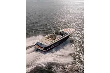 Slide: The Image of 2016 Chris-Craft Capri 21 boat cruising on open water, creating a dynamic wake. - 5