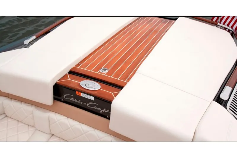 Slide: The Image of Manufacturer Provided Image: 2016 Chris-Craft Capri 21 boat with teak wood deck and white cushioned seating. - 8