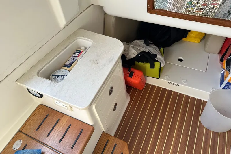 Slide: The Image of Interior of 2019 Sailfish 360 CC boat with storage and wooden flooring. - 12