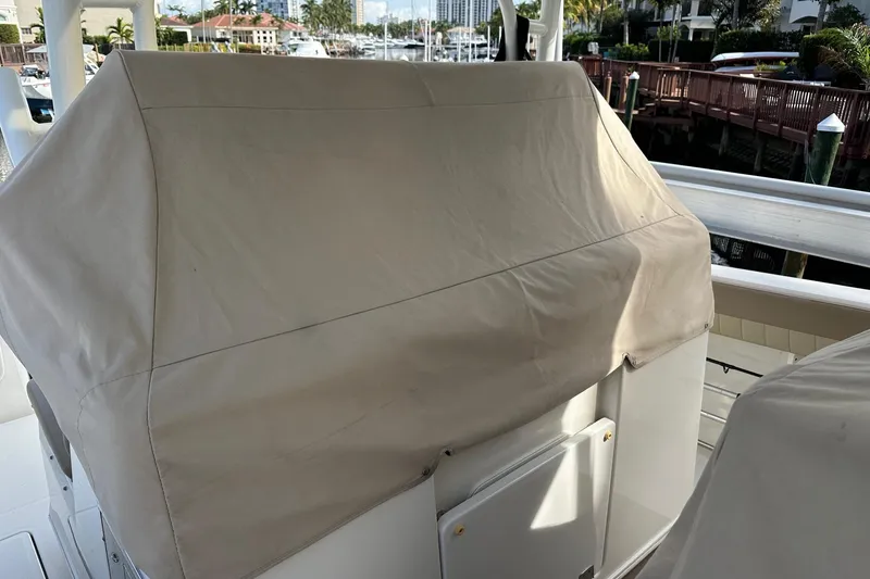Slide: The Image of Covered console of a 2019 Sailfish 360 CC boat docked at a marina. - 18