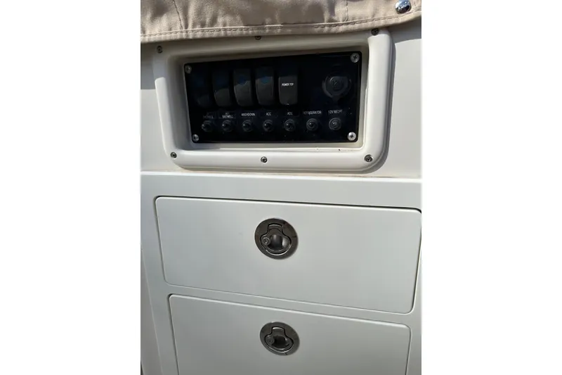Slide: The Image of Control panel and storage on 2019 Sailfish 360 CC boat. - 24