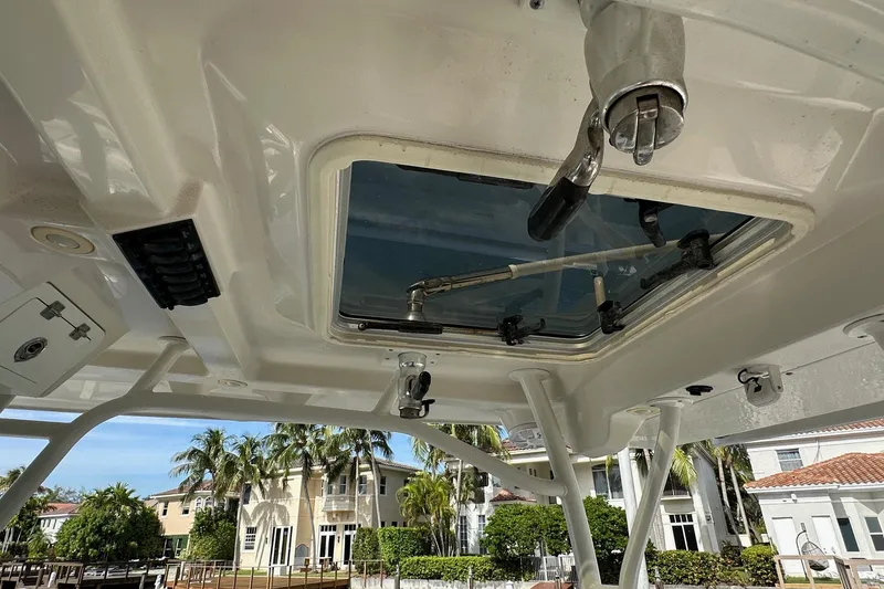 Slide: The Image of 2019 Sailfish 360 CC boat interior with open hatch, showcasing tropical background. - 25