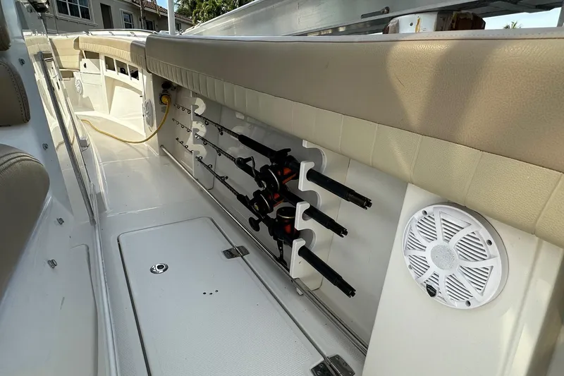 Slide: The Image of 2019 Sailfish 360 CC boat interior with rod holders and speaker. - 26