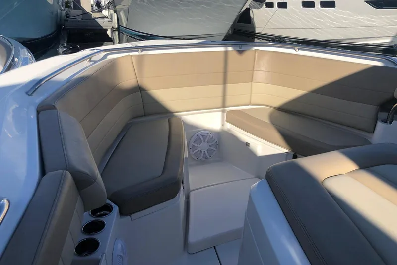 Slide: The Image of 2019 Sailfish 360 CC boat interior with beige seating and cup holders. - 3