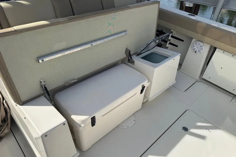 Slide: The Image of 2019 Sailfish 360 CC boat interior with storage and seating area. - 30