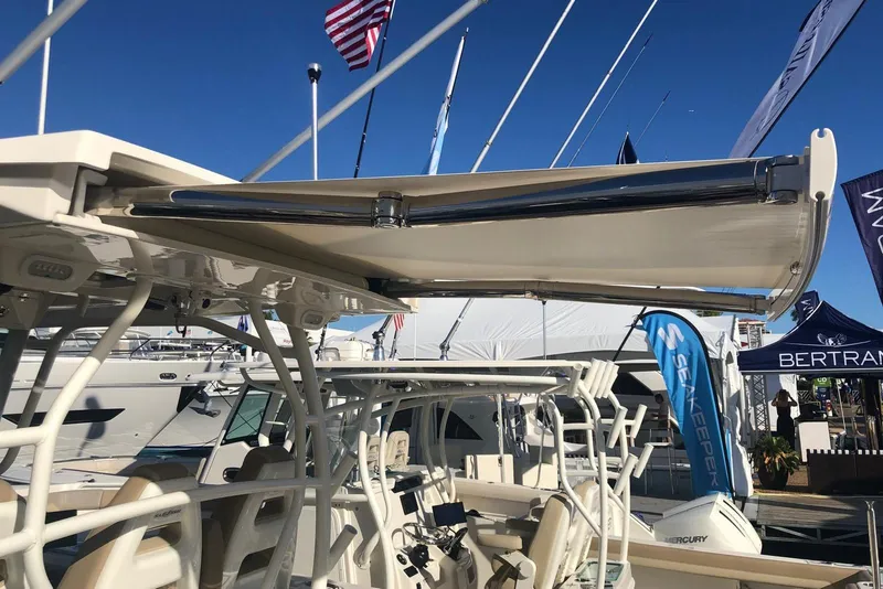 Slide: The Image of 2019 Sailfish 360 CC boat with retractable canopy at a boat show. - 33