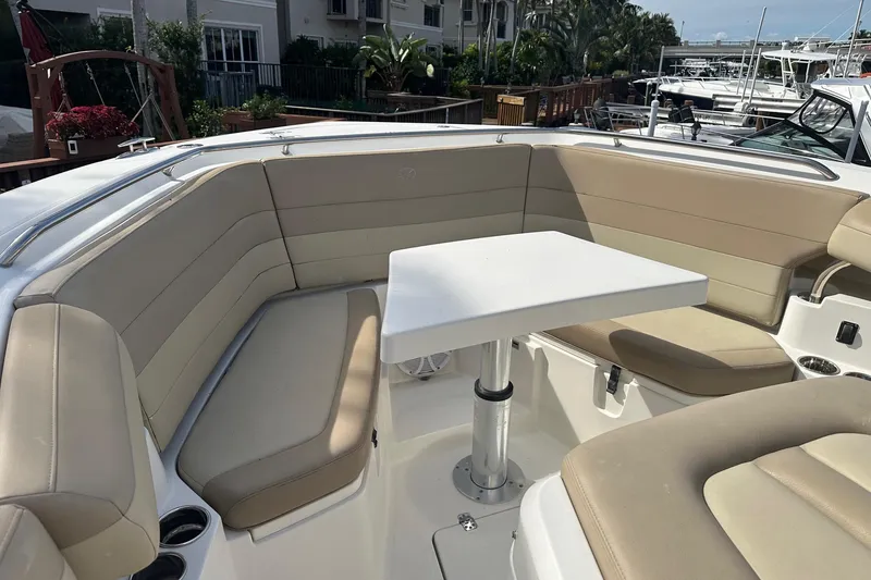 Slide: The Image of 2019 Sailfish 360 CC boat interior with beige seating and a white table. - 4