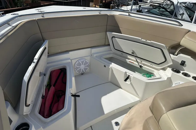 Slide: The Image of 2019 Sailfish 360 CC boat interior with open storage compartments and seating. - 6
