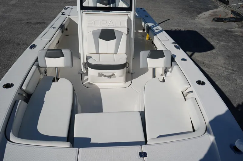 Slide: The Image of 2023 Robalo 246 Cayman boat interior with white seating and console. - 3