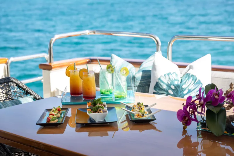 Slide: The Image of Luxurious dining setup on Azimut Grande 32M yacht with cocktails and appetizers by the sea. - 18