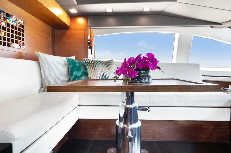 Slide: The Image of Luxurious Azimut Grande 32M yacht pilot house with elegant seating and vibrant purple orchids. - 29