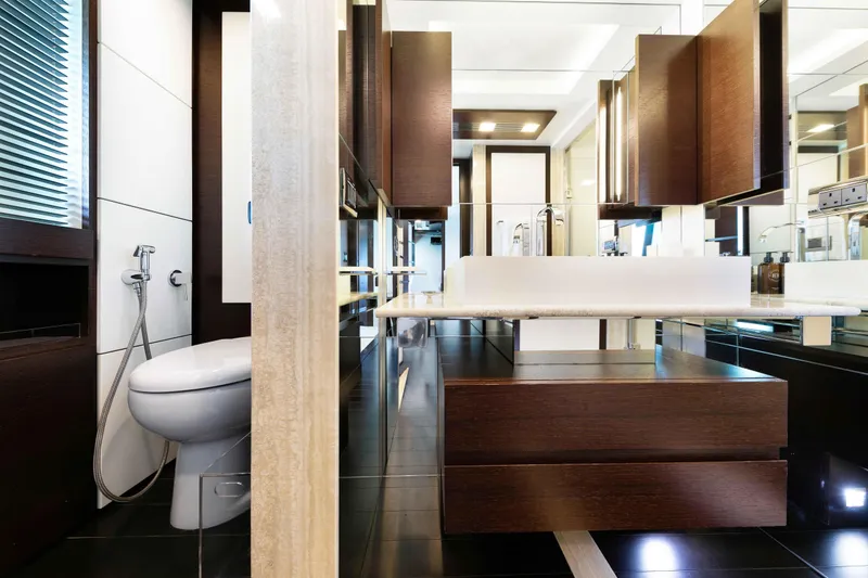 Slide: The Image of Luxurious Master bathroom with his/and hers and a walk-through shower on the 2012 Azimut Grande 32M yacht, featuring modern fixtures and elegant design. - 38