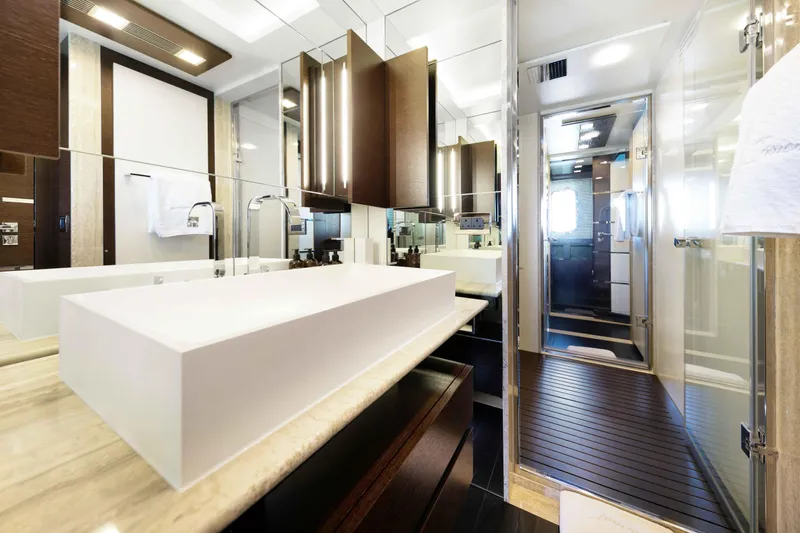 Slide: The Image of Luxurious Master bathroom with his/and hers and a walk-through shower on the 2012 Azimut Grande 32M yacht, featuring modern fixtures and elegant design. - 39
