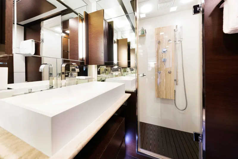 Slide: The Image of Luxurious Master bathroom with his/and hers and a walk-through shower on the 2012 Azimut Grande 32M yacht, featuring modern fixtures and elegant design. - 40