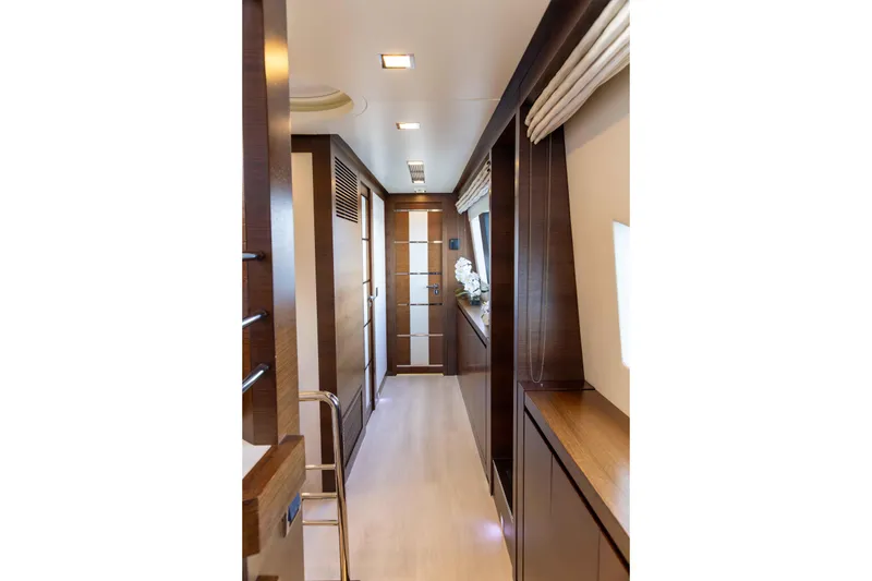Slide: The Image of Luxurious hallway below deck connecting Master, Twin x 2, and Lower VIP cabins of the 2012 Azimut Grande 32M yacht, with elegant wood finishes. - 41
