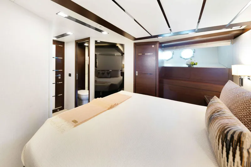 Slide: The Image of Luxurious lower VIP cabin on 2012 Azimut Grande 32M yacht, featuring elegant wood finishes. - 43