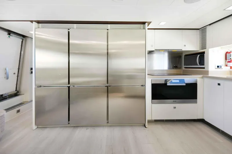 Slide: The Image of Modern kitchen interior on 2012 Azimut Grande 32M yacht, featuring stainless steel appliances. - 56
