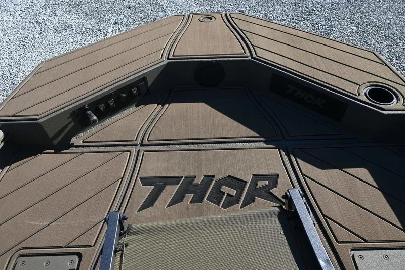 Slide: The Image of Thor 1900 Lake Hammer Center Console Elite 2026 boat deck with logo and controls. - 10