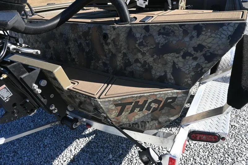 Slide: The Image of 2026 Thor 1900 Lake Hammer Center Console Elite with camouflage design on a trailer. - 3