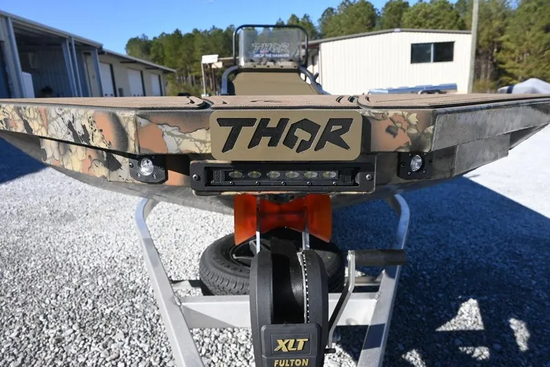Slide: The Image of 2026 Thor 1900 Lake Hammer Center Console Elite boat on trailer, camo design. - 4