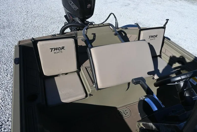 Slide: The Image of 2026 Thor 1900 Lake Hammer Center Console Elite boat interior with beige seating. - 5