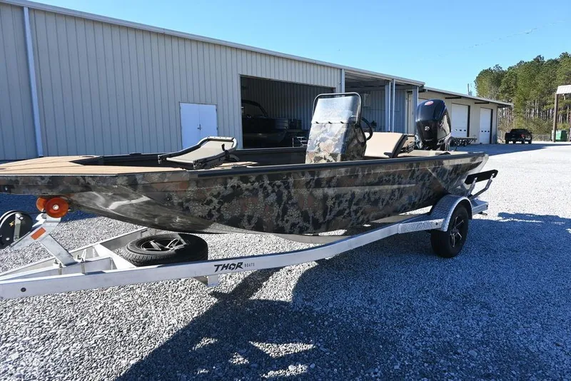 Slide: The Image of 2026 Thor 1900 Lake Hammer Center Console Elite boat on trailer, outdoors. - 7
