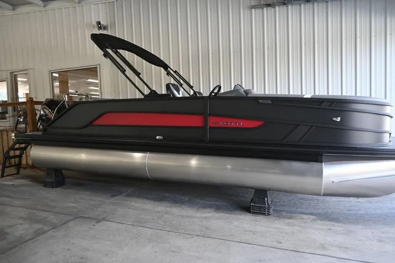 The Image of 2026 Evotti 523CS pontoon boat in showroom, featuring sleek black and red design. - 1