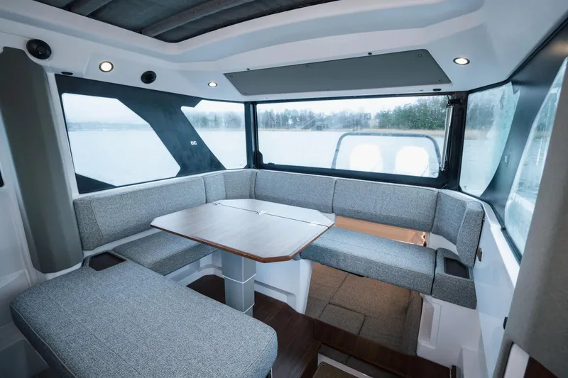 Slide: The Image of Interior of 2026 Axopar 38 Cross Cabin with modern seating and panoramic windows. - 15