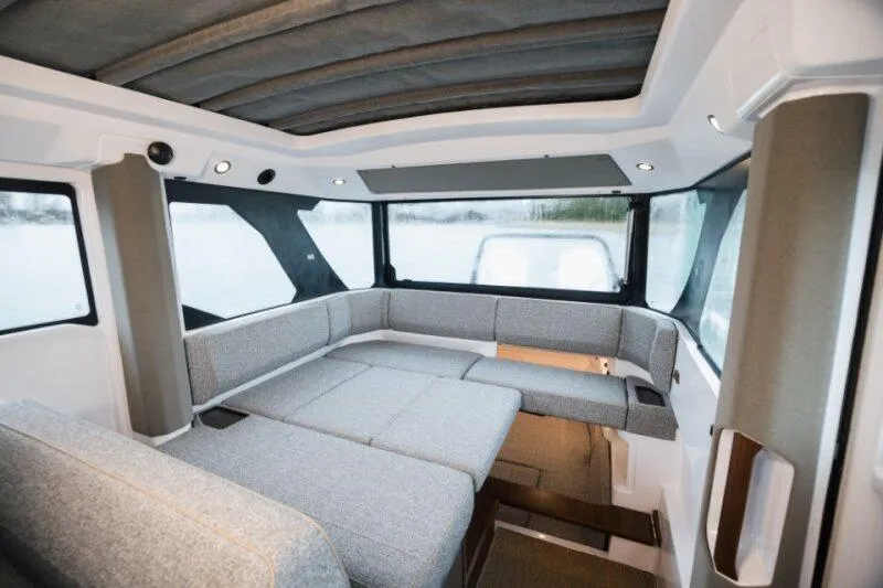 Slide: The Image of Interior of 2026 Axopar 38 Cross Cabin with modern seating and panoramic windows. - 16