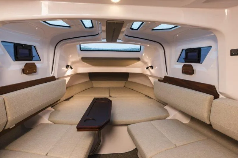 Slide: The Image of 2026 Axopar 38 Cross Cabin interior with modern seating and skylights. - 21